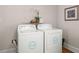 Laundry room equipped with a modern washer and dryer set, and a shelf for storage at 672 W Oak Forest Dr, Charleston, SC 29407