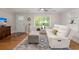 Inviting living room features wood floors, a comfortable sofa, and plenty of natural light at 672 W Oak Forest Dr, Charleston, SC 29407