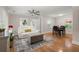 Open-concept living space featuring hardwood floors, modern furnishings, and a seamless flow to the dining area at 672 W Oak Forest Dr, Charleston, SC 29407