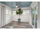 Bright sunroom featuring a blue ceiling, lots of windows and a large potted tree at 672 W Oak Forest Dr, Charleston, SC 29407