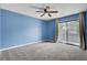 Bedroom featuring carpet floors, blue walls, and a sliding door to a balcony at 807 Greencastle Dr, Goose Creek, SC 29445