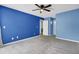 Large bedroom with blue walls, plush carpet, and a door leading to another room at 807 Greencastle Dr, Goose Creek, SC 29445