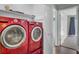 Laundry area featuring modern red washer and dryer sets with convenient shelving at 807 Greencastle Dr, Goose Creek, SC 29445