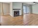 Spacious living room boasts hardwood flooring, a fireplace, and sliding door access to the balcony at 807 Greencastle Dr, Goose Creek, SC 29445