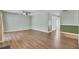 Open-concept living room featuring wood floors, fresh wall colors, and a modern ceiling fan at 807 Greencastle Dr, Goose Creek, SC 29445