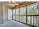 Covered porch with white wood paneling, ceiling fan, and outdoor access through a white door at 807 Greencastle Dr, Goose Creek, SC 29445