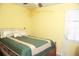 Bright bedroom with yellow walls, a cozy bed, and natural lighting at 814 Armsway St, Mount Pleasant, SC 29464