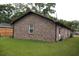 Back exterior of a brick house with a well-kept lawn and fenced in yard at 814 Armsway St, Mount Pleasant, SC 29464