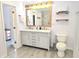Well-lit bathroom with a double sink vanity, wooden mirror frame, and modern fixtures at 9489 Sidneys Rd, Round O, SC 29474