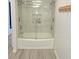 Bathroom with glass shower doors and gray tiled walls and floors at 9489 Sidneys Rd, Round O, SC 29474