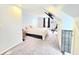 Spacious bedroom with a queen bed, mounted TV, and carpet flooring at 9489 Sidneys Rd, Round O, SC 29474
