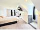 Bright bedroom features sloped ceilings, a bed, wall mounted TV and a storage nook at 9489 Sidneys Rd, Round O, SC 29474