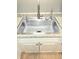 Stainless steel kitchen sink with modern faucet, set in neutral countertop and white cabinets at 9489 Sidneys Rd, Round O, SC 29474