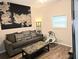 Cozy living room with a plush sofa, patterned pillows, and a unique wall map at 9489 Sidneys Rd, Round O, SC 29474