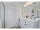 Well-lit bathroom with dual vanity sinks, white cabinets, and a large mirror at 9624 Scarborough Ct, Summerville, SC 29485