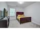 Bedroom with a dark wood bed frame and TV, showcasing a simple and cozy space at 9624 Scarborough Ct, Summerville, SC 29485