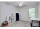 Bright bedroom with neutral carpet features a ceiling fan and large window at 9624 Scarborough Ct, Summerville, SC 29485