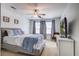 Cozy bedroom with a queen-sized bed, ceiling fan, and large TV at 9624 Scarborough Ct, Summerville, SC 29485