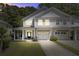 Townhome with a welcoming front porch, two-car garage, and a well-manicured lawn at 9624 Scarborough Ct, Summerville, SC 29485