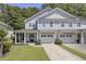Charming gray townhome with a well-manicured lawn, covered front porch, and two-car garage at 9624 Scarborough Ct, Summerville, SC 29485