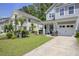 View of the charming gray townhome with well-manicured lawn and covered front porch at 9624 Scarborough Ct, Summerville, SC 29485