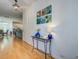 Bright foyer featuring hardwood floors, modern lighting, and stylish decor at 9624 Scarborough Ct, Summerville, SC 29485