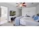 Comfortable main bedroom with a TV, a ceiling fan, an attached bathroom, and carpet floors at 9624 Scarborough Ct, Summerville, SC 29485