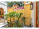 Charming balcony view of yellow building with red roof and palm trees, offering a vibrant and picturesque scenery at N Blvd, Mount Pleasant, SC 29464