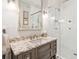 Bright bathroom featuring a granite vanity, subway tile shower with glass door, and contemporary fixtures at N Blvd, Mount Pleasant, SC 29464