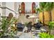 Serene courtyard featuring an umbrella table, manicured landscaping, palm trees, and a charming seating area at N Blvd, Mount Pleasant, SC 29464