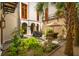 Charming courtyard featuring lush landscaping, palm trees, comfortable seating, a fountain, and access to the home at N Blvd, Mount Pleasant, SC 29464