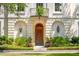 Charming entrance with manicured landscaping and a classic arched doorway, number 174, flanked by lantern sconces at N Blvd, Mount Pleasant, SC 29464