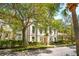 An elegant home showcasing mature trees and landscaping along with a lovely front-facing balcony at N Blvd, Mount Pleasant, SC 29464
