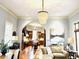 Open-concept living room with an archway to the kitchen, hardwood floors, and a modern light fixture at N Blvd, Mount Pleasant, SC 29464