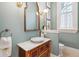 Charming powder room with unique vessel sink, decorative mirror, stylish lighting, and a window at N Blvd, Mount Pleasant, SC 29464