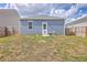 Backyard with a wood fence, small patio with outdoor furniture, and a two-story house at 1003 Peridote Way, Ladson, SC 29456