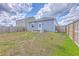 Backyard featuring a wood fence, a small patio with outdoor furniture, and a two-story house at 1003 Peridote Way, Ladson, SC 29456
