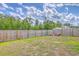 View of a grassy backyard enclosed by a wooden fence, providing privacy and space for outdoor activities at 1003 Peridote Way, Ladson, SC 29456