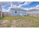 View of the backyard with a wood fence, small patio, and a two-story house at 1003 Peridote Way, Ladson, SC 29456