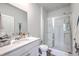 Bathroom featuring a single sink vanity, large mirror, and a shower with a glass door at 1003 Peridote Way, Ladson, SC 29456