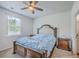 Comfortable bedroom featuring a ceiling fan, large window, and a full size bed with a tufted headboard at 1003 Peridote Way, Ladson, SC 29456