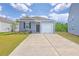 Charming single-Gathering home with a garage and a well-maintained lawn on a sunny day at 1003 Peridote Way, Ladson, SC 29456