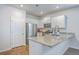 Bright kitchen showcasing granite counters, white cabinets, stainless steel appliances, and wood-look flooring at 1003 Peridote Way, Ladson, SC 29456