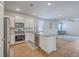 Modern kitchen featuring granite countertops, stainless steel appliances, and an open concept layout at 1003 Peridote Way, Ladson, SC 29456