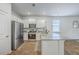Well-lit kitchen with a large island, stainless steel appliances, and seamless flow into the dining area at 1003 Peridote Way, Ladson, SC 29456