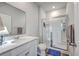 Modern bathroom with a glass-enclosed shower, white cabinets, and wood-look vinyl floors at 1011 Peridote Way, Ladson, SC 29456