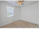 Neutral bedroom with a ceiling fan, window for natural light, and plush carpeting at 1011 Peridote Way, Ladson, SC 29456
