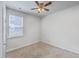 Well-lit bedroom with neutral carpet, a ceiling fan, and a window offering outdoor views at 1011 Peridote Way, Ladson, SC 29456
