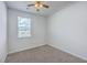 Cozy bedroom featuring neutral carpet, a ceiling fan, and a window for natural light at 1011 Peridote Way, Ladson, SC 29456