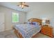 Bright bedroom featuring a ceiling fan, window, and stylish blue-and-white patterned bedding at 1011 Peridote Way, Ladson, SC 29456